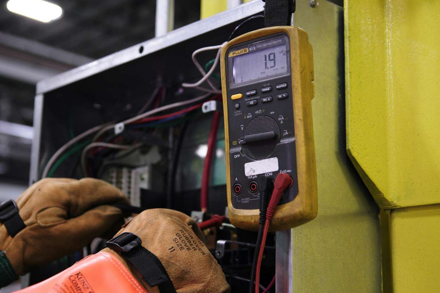 person doing electrical troubleshooting for industrial equipment